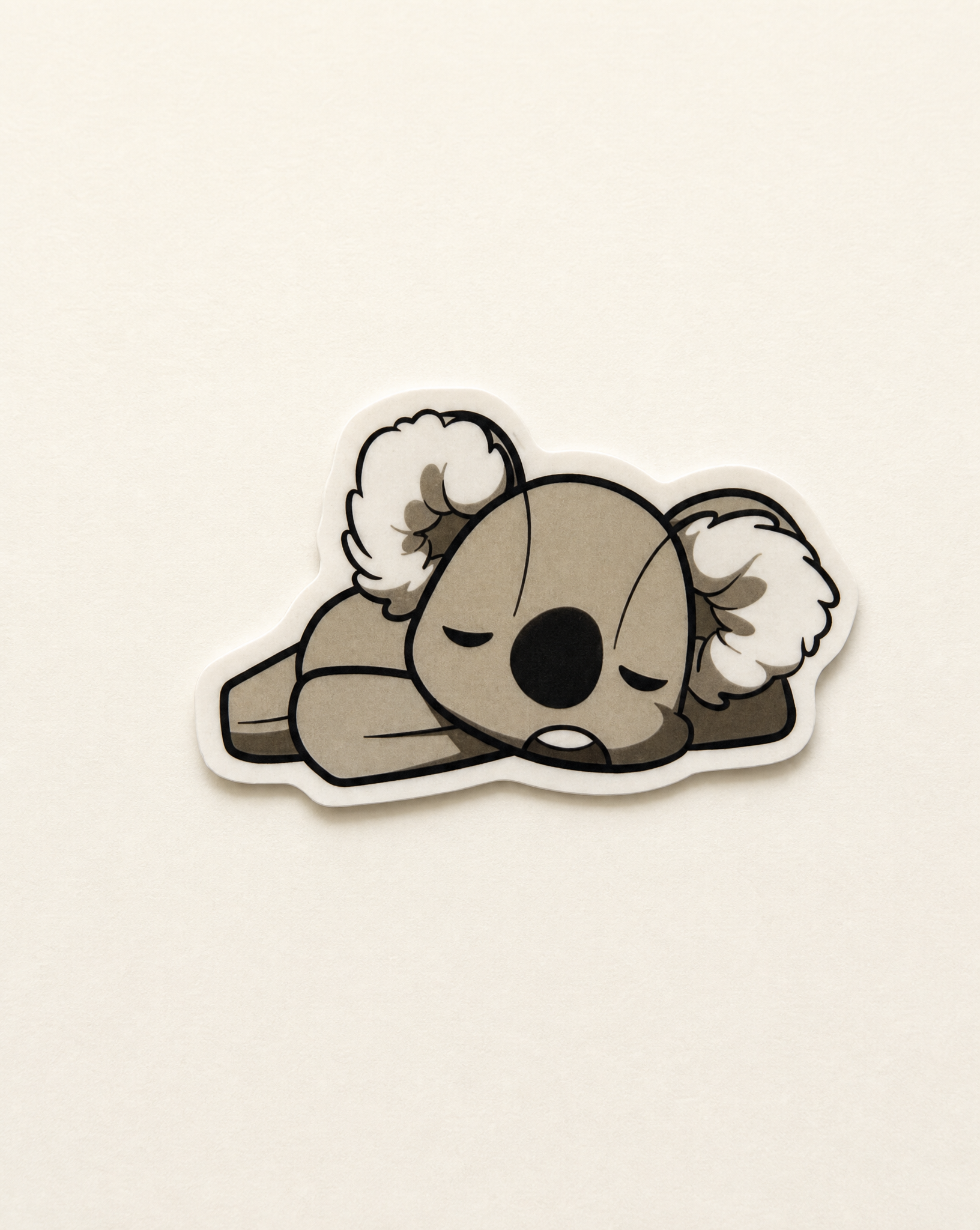 Koko the Koala collectible sticker on a warm off-white background