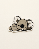 Koko the Koala collectible sticker on a warm off-white background