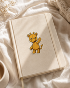 Giggles the Giraffe sticker on a journal